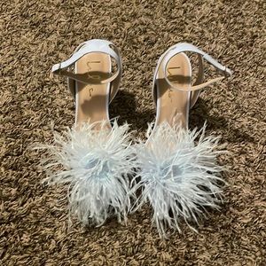 Lulu’s feathered high heel. Warn once